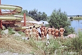 Hungary, Delegyhaza, 1988, naturist, nudist, group, naturist group, naturist woman, naturist man, nudist women, nudist man, naturist girl, girls, naturist family, young, mother, youthfulness, sun, sunlight, sun-bathing, sunbathing, recreation, relaxation, repose, rest, slide-way, slip-way, water-chute, disengagement, distraction, resource, nature, summer, holidays, fry, swelter, health, loose, joyful, joyfully, glad, as brown as a berry, near nature, beach, waterfront, lake, lake side, field naturist, CD 0037
