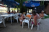 naturism, naturist, nudism, nudist, fkk, INF, NFN, unclad, stripped, naked, in a state of nature, in the buff, in the nude, beach, naturist beach, visitor, naturist guest, naturism club, naturist beach and camping, hospitality, bar, pub, buffet, canteen, tables, chairs, sunshade, shady, adumbral, shaded, woman, man, kid, game, bean, ball, to play, puppeteer, amuse, entertain, tree, trees, lake, lake side, 2007, CD 0051, Kiss L�szl�, L�szl� Kiss