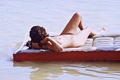 naturist, nudist, naturist woman, naturist man, nudist women, nudist man, naturist girl, naturist family, sun, sunlight, bathe, bathing, swim, mattress, beach mattress, inflatable raft, water, cold, cold water, sun-bathing, sunbathing, recreation, relaxation, repose, rest, on the water, disengagement, distraction, resource, nature, summer, holidays, fry, swelter, health, as brown as a berry, near nature, beach, waterfront, lake, lake side, field naturist, Polish, Poland, Kryspinow, 1989, CD 0036, Kiss Lszl, Lszl Kiss