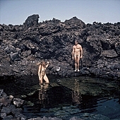 bay, gulf, nudist couple, nudist pair, naked, stripped, beach, coast, naturist couple, naturist, holidays, nudist, on holiday, recreation, relaxation, repose, rest, rock coast, game, nudism, naturism, attitude, pose, posture, stony, craggy, clear, hygienic, pure, clean, Hawaii, Kona, Honokohau, Queen s Bath, 1987, man, woman, bath, bathe, bathing, water, stone, stones, rock, scrag, bush, CD 0091