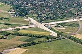 highway, aerial, road, E5, E75, Szeged, Budapest, air photograph, air photo, Kecskemet, Kiskunfelegyhaza, Hungary, transportation, traffic, horticulture, barrier, bar, fence, birds eye view, banister, delimination, bridge, holiday home, holiday resort, house, houses, overpass, perspective, nature, bridges, power-line, wire, fruit tree, plantation, electric line, car, cars, lane, lanes, painted lane, speed, range of speeds, fast, fast transportation, menacing, cloud, clouds, sky, cut, dike, ditch, pit, trench, water-jump, asphalt, bitumen, blacktop, concrete, standing, arc of a circle, arc, holidaymakers, Kiss L�szl�, L�szl� Kiss