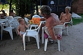 naturism, naturist beach and camping, naturist, nudism, nudist, fkk, INF, NFN, unclad, stripped, naked, in a state of nature, in the buff, in the nude, beach, naturist beach, visitor, naturist guest, naturism club, hospitality, bar, pub, buffet, canteen, tables, chairs, sunshade, shady, adumbral, shaded, woman, man, kid, game, bean, ball, to play, puppeteer, amuse, entertain, tree, trees, lake, lake side, 2007, CD 0051, Kiss Lszl, Lszl Kiss