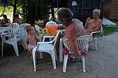 naturism, naturist beach and camping, naturist, nudism, nudist, fkk, INF, NFN, unclad, stripped, naked, in a state of nature, in the buff, in the nude, beach, naturist beach, visitor, naturist guest, naturism club, hospitality, bar, pub, buffet, canteen, tables, chairs, sunshade, shady, adumbral, shaded, woman, man, kid, game, bean, ball, to play, puppeteer, amuse, entertain, tree, trees, lake, lake side, 2007, CD 0051, Kiss L�szl�, L�szl� Kiss