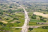 highway, road making, air photograph, road, M5, E5, E75, Szeged, Budapest, air photo, Kecskemet, Kiskunfelegyhaza, Hungary, transportation, traffic, horticulture, barrier, bar, fence, birds eye view, banister, delimination, bridge, holiday home, holiday resort, holidaymakers, house, houses, overpass, perspective, nature, bridges, power-line, wire, fruit tree, plantation, electric line, car, cars, lane, lanes, painted lane, speed, range of speeds, fast, fast transportation, menacing, cloud, clouds, sky, cut, dike, ditch, pit, trench, water-jump, asphalt, bitumen, blacktop, concrete, standing, arc of a circle, arc, Kiss L�szl�, L�szl� Kiss