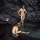 nudist couple, nudist pair, naked, stripped, naturist couple, naturist, holidays, nudist, on holiday, recreation, relaxation, repose, rest, rock coast, game, beach, coast, nudism, naturism, attitude, pose, posture, stony, craggy, bay, gulf, clear, hygienic, pure, clean, Hawaii, Kona, Honokohau, Queen s bath, 1987, Cynthia, Calderone, Mark, Mallory, man, woman, bath, bath, bathe, bathing, water, stone, stones, rock, scrag, bush, CD 0091