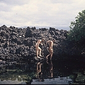 naturism, naturist, unclad, stripped, nudism, nudist, naturist couple, nudist couple, nudist pair, naked, beach, coast, rock coast, stony, craggy, bay, gulf, clear, hygienic, pure, clean, Hawaii, Kona, Honokohau, Queen s bath, 1987, man, woman, bath, bath, bathe, bathing, water, stone, stones, rock, scrag, bush, CD 0090