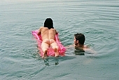 naturist beach, bathe, bathing, beach mattress, inflatable raft, unclad woman, nudist couple, nudist pair, pair, man, woman, INF, swim, taking photographs, attitude, pose, nude, nudity, girl, naked girl, unclad body, young naturists, naked body, nude body, nudist place, lake, lake side, water, waterfront, grit cell, gravel, gravelly, tattooed, fkk, posture, naturist girl, in a state of nature, in the buff, in the nude, naturism, unclad, stripped, nudist, nudism, naturist, friend, young, naked, game, recreation, relaxation, repose, rest, sand, camping, beach, Delegyhaza, CD 0095