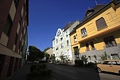 Szeged, town, city, street, house, houses, condominium, condo, big house, renewes, renovated, freshly painted, green, white, yellow, red, pavement, side-walk, sidewalk, tree, trees, sky, canopy of heaven, cope of heaven, firmament, blue, blue sky, power-line, electric line, narrow street, alley, mediterranean, city sight, perspective, slant, slanting, light, sunlight, sunshine, car, shadow, painted, Trabant, opposite, architecture, Kiss Lszl, Lszl Kiss